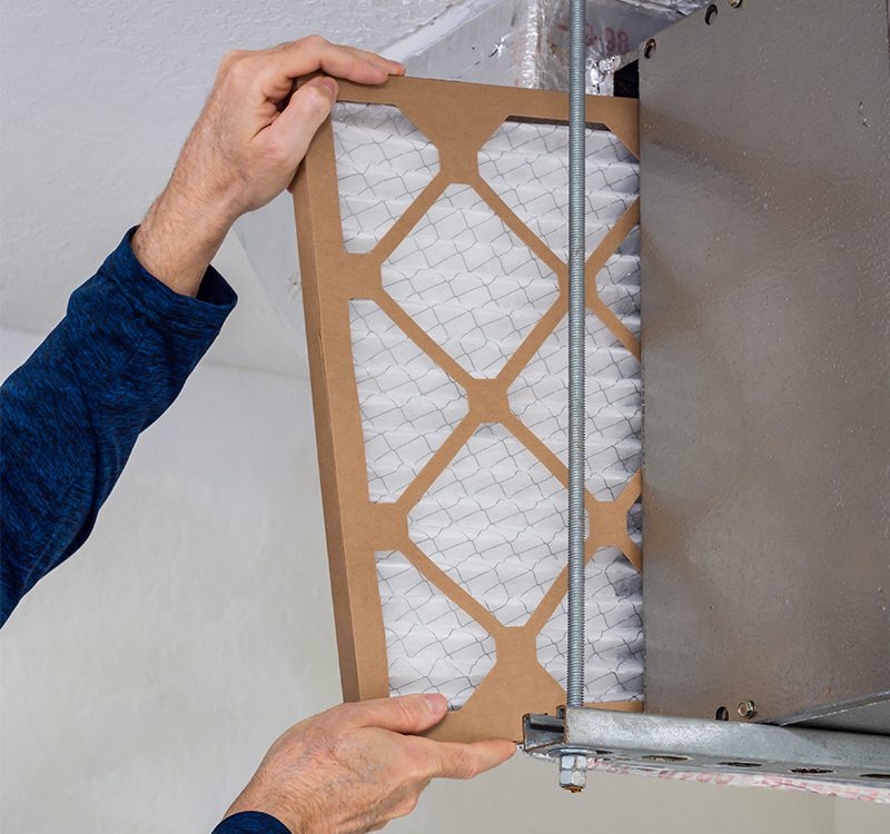 Indoor air quality solutions include changing the air filters in your HVAC system as shown here