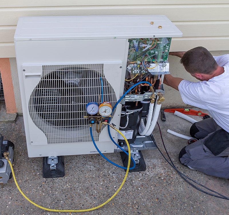 Heat Pumps in Tillsonburg include maintenance & repair as shown with this technician doing a heat pump repair