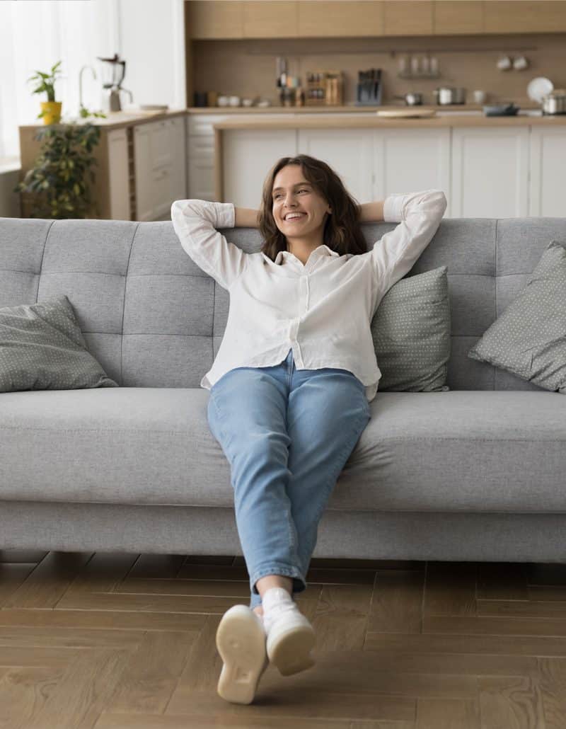 woman relaxing at home with her heating and cooling needs met